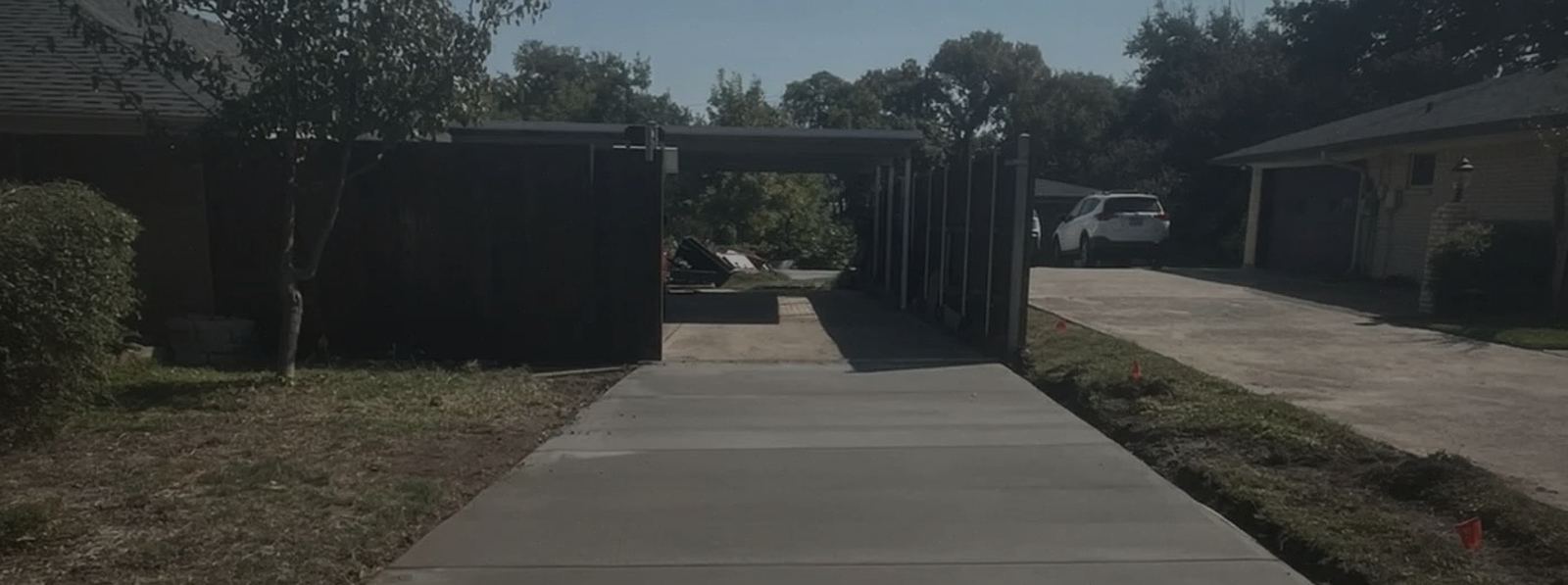 A finished residential concrete driveway poured by Lucky's Concrete.